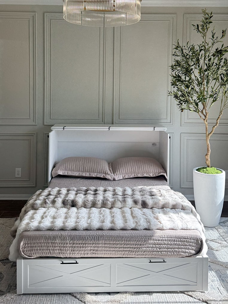 White Key West collection cabinet bed with gray bedding in a room with gray paneled walls and a plant.