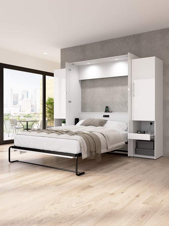 Modern bedroom with a Murphy bed in an open-plan living area.