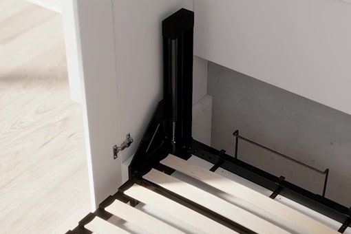 Black metal bed frame against a white wall