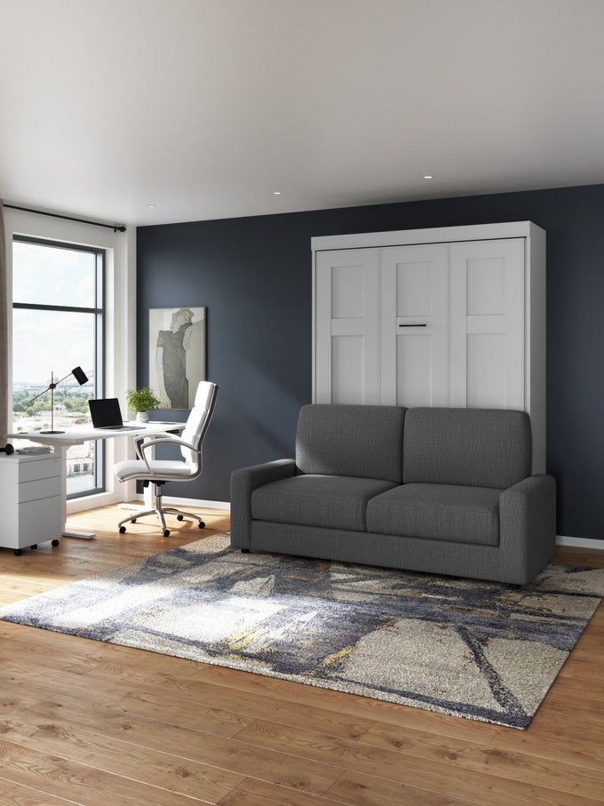 Gray sofa bed, Edge collection, in a room with a desk and window