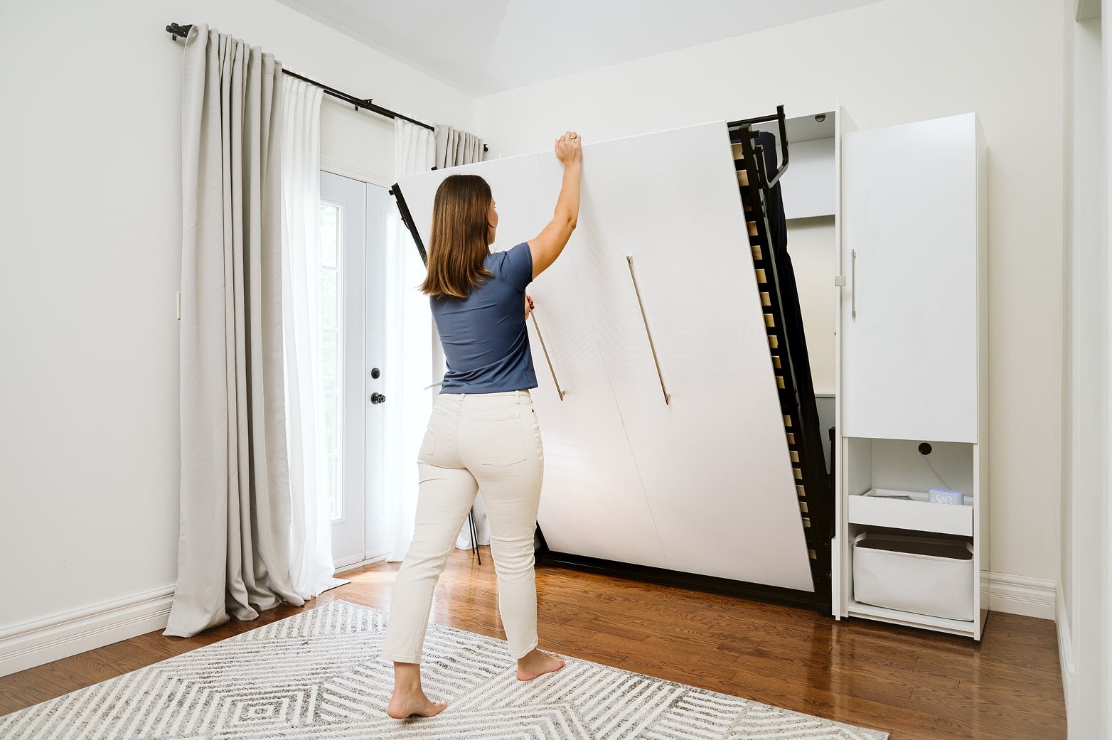 Woman opening the Avalon Collection Murphy Bed 