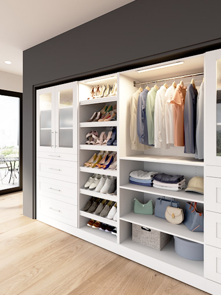 Florence collection modern walk-in closet with white shelves, clothes, shoes, and bags.