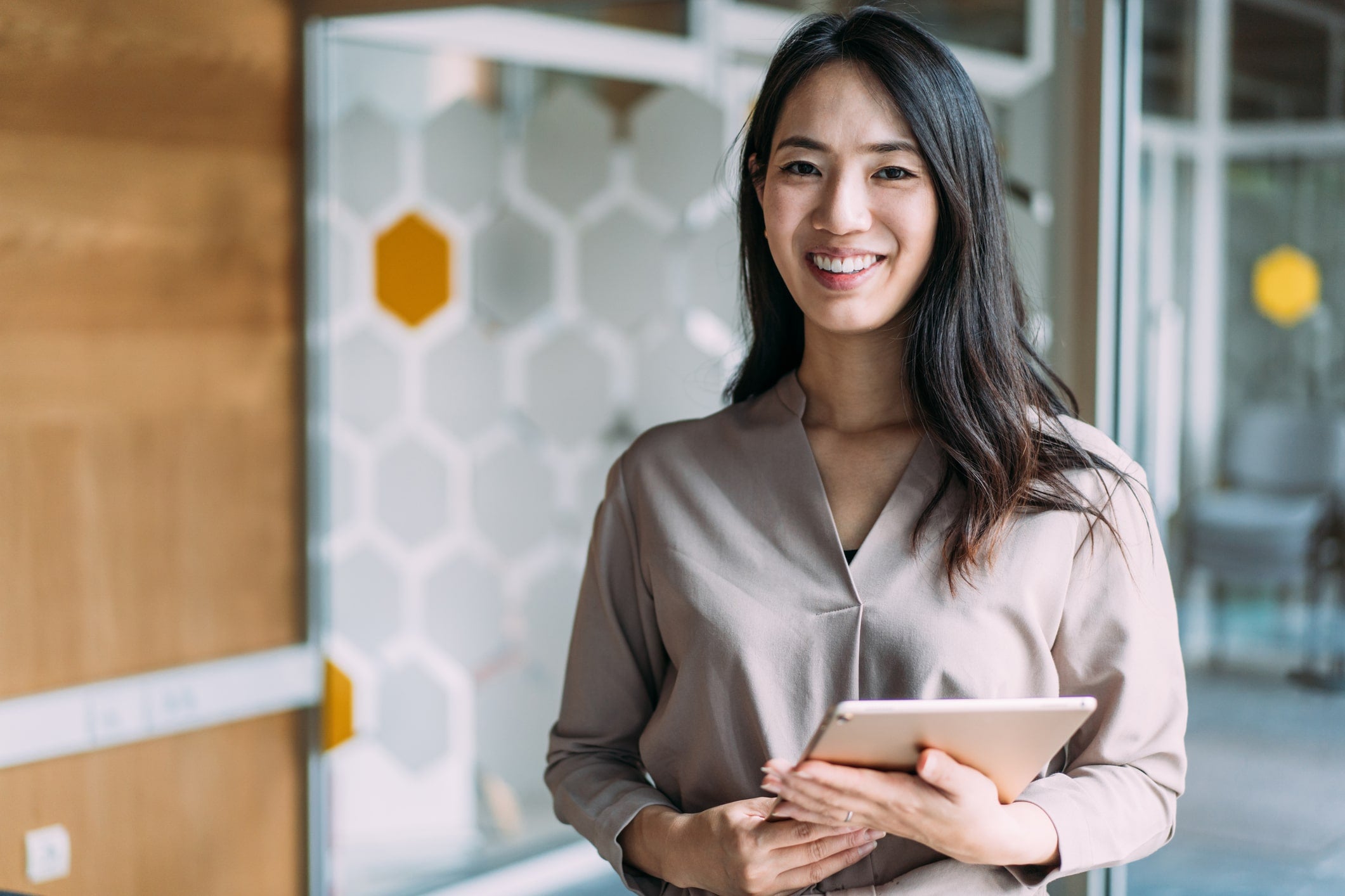 Woman holding a tablet in an office setting