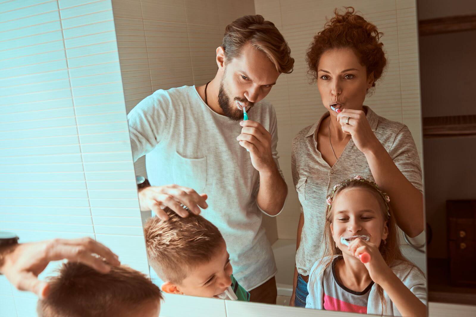 Family brushing their teeth together