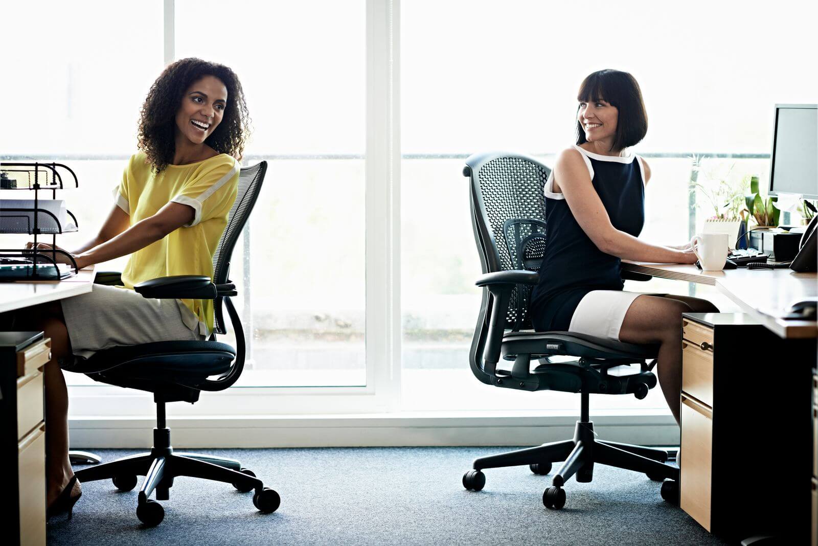 Female workers in office chairs