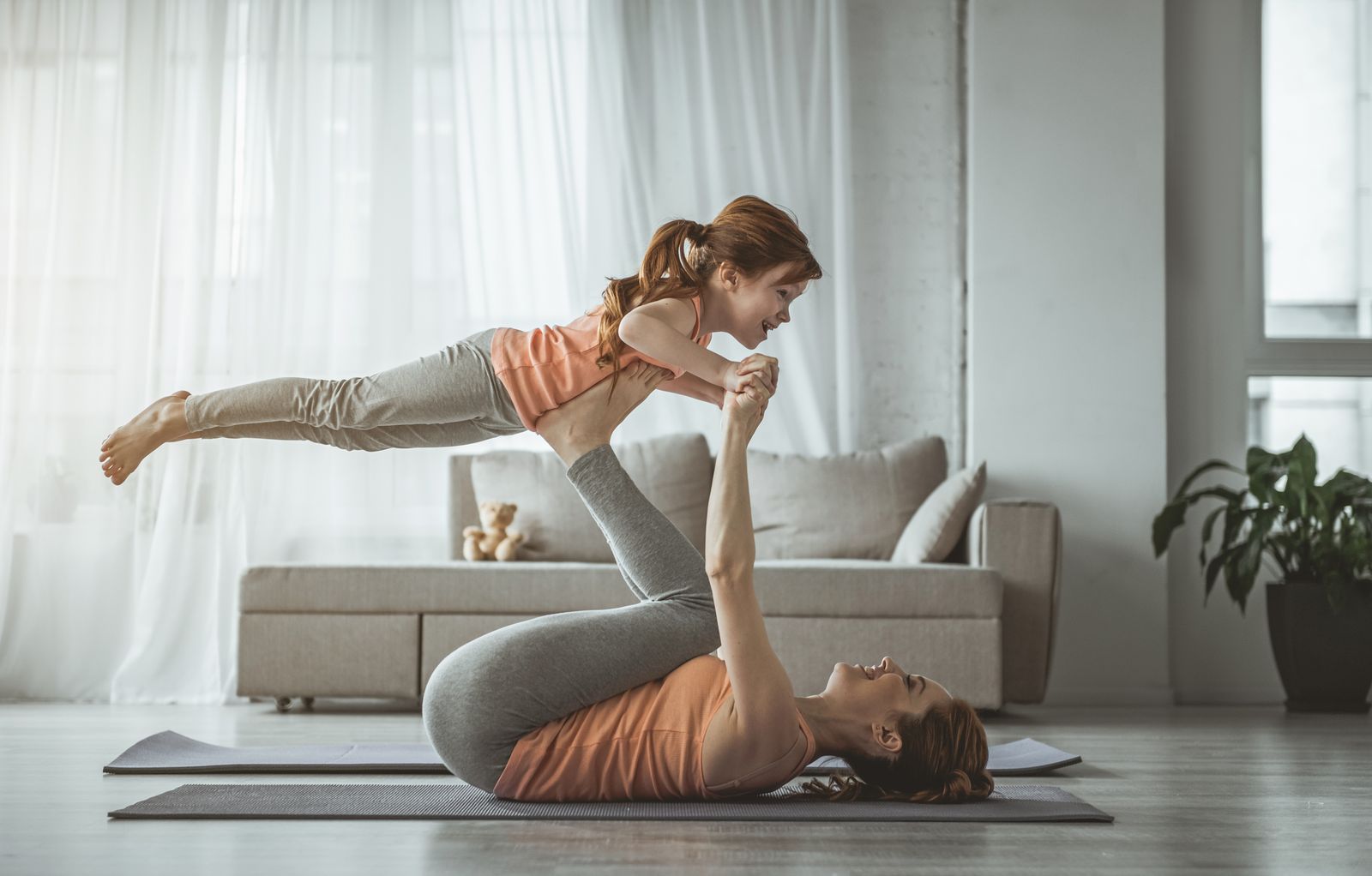 Mother and daughter doing yoga together