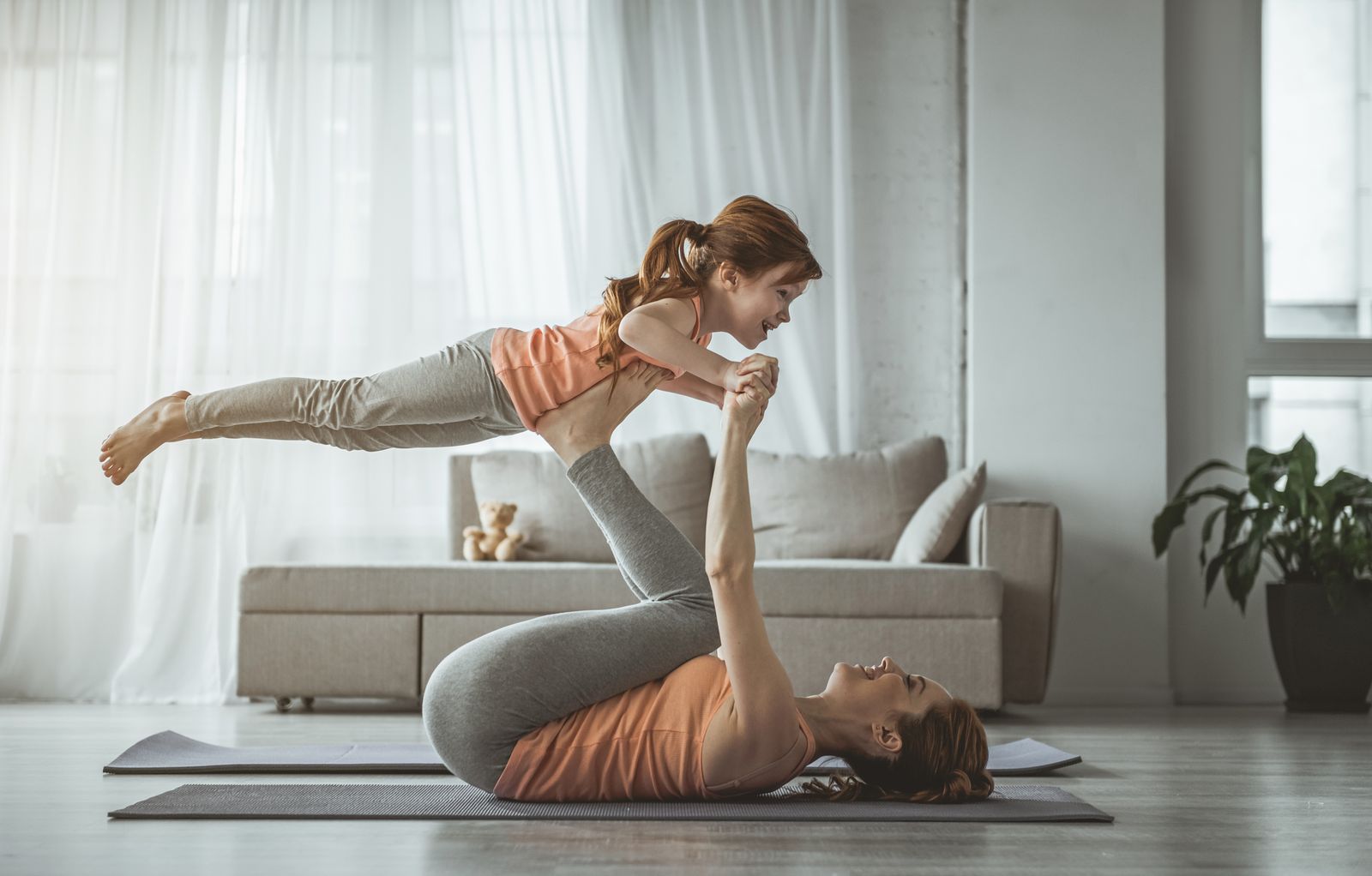 Mother and daughter doing yoga together