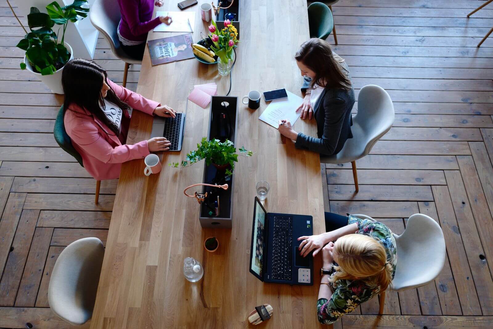 Women working at large, open desk