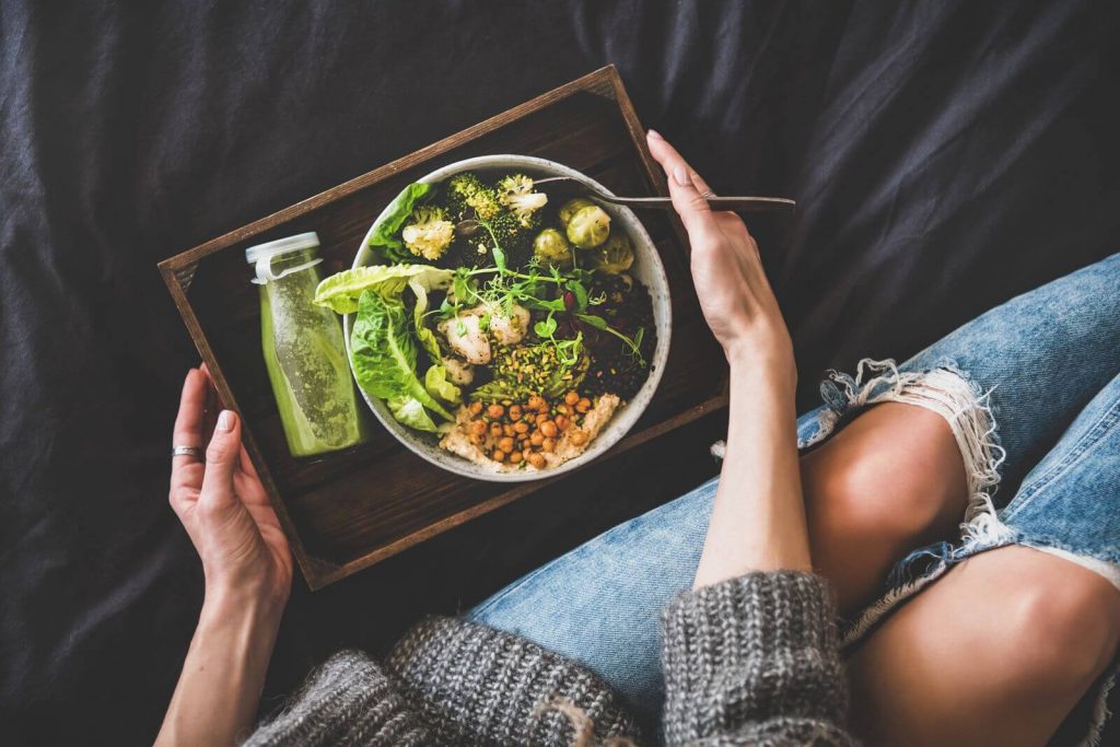 Woman with bowl of healthy greens