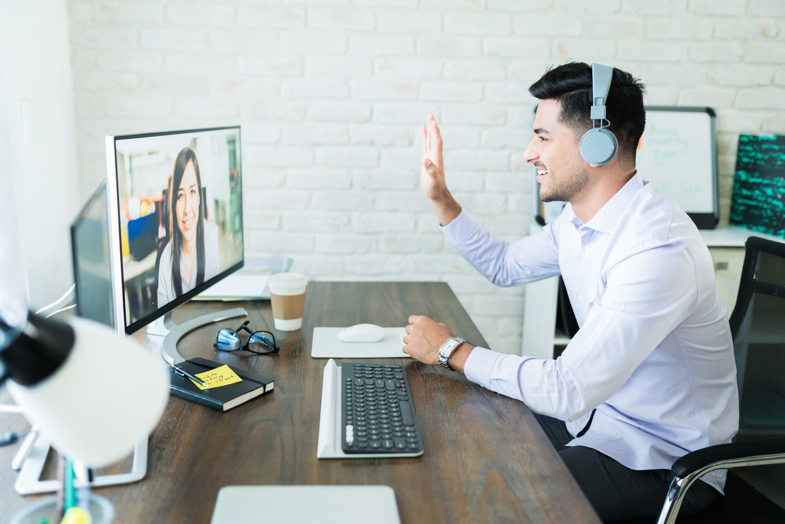 Young man videoconferencing with his coworker