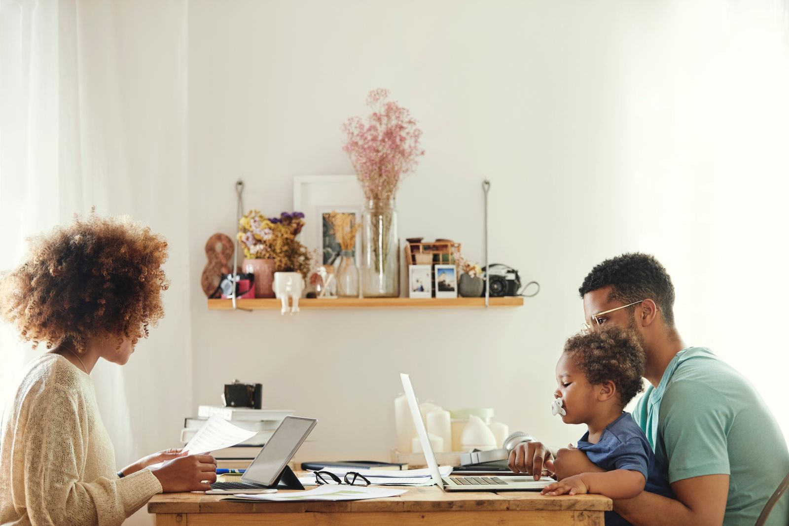 Young couple working from home with their child