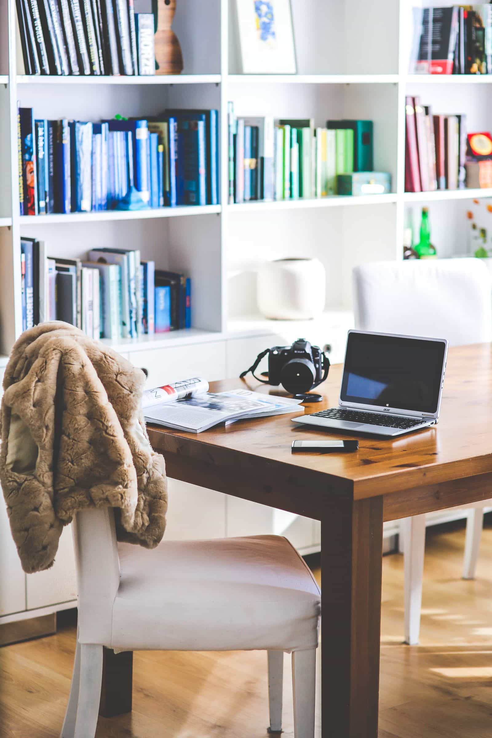 Colorful home office with rainbow bookshelves