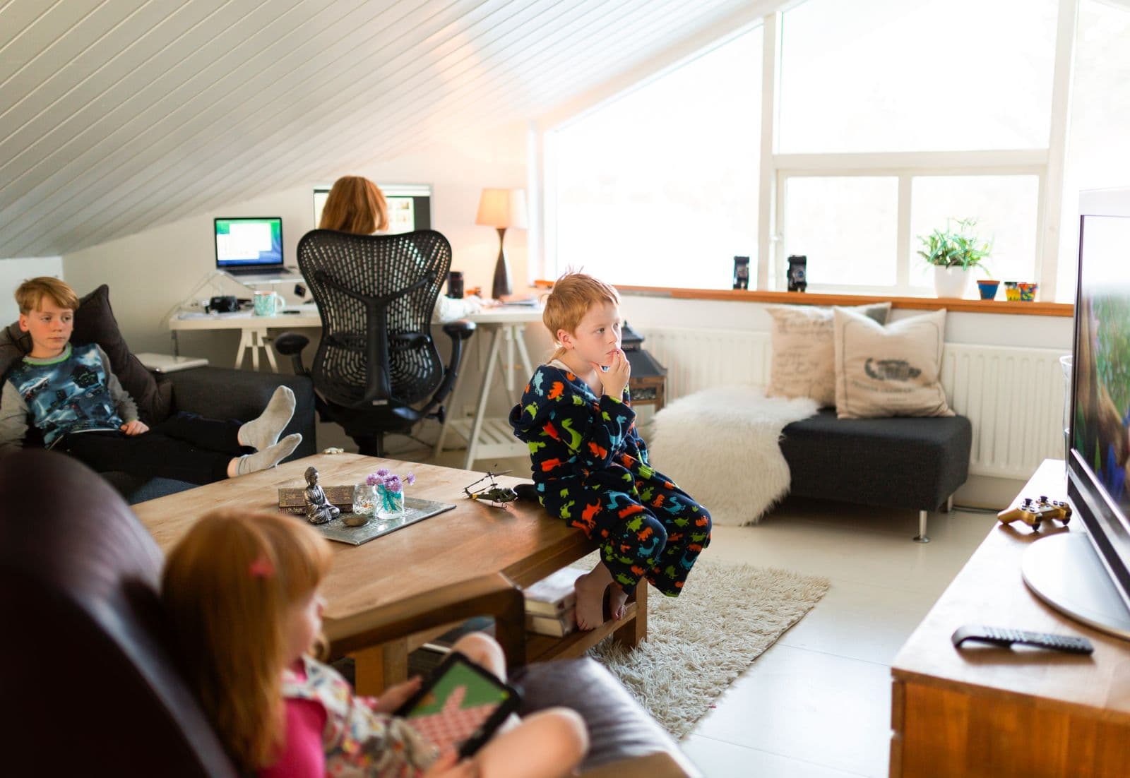 Mother working at home with children