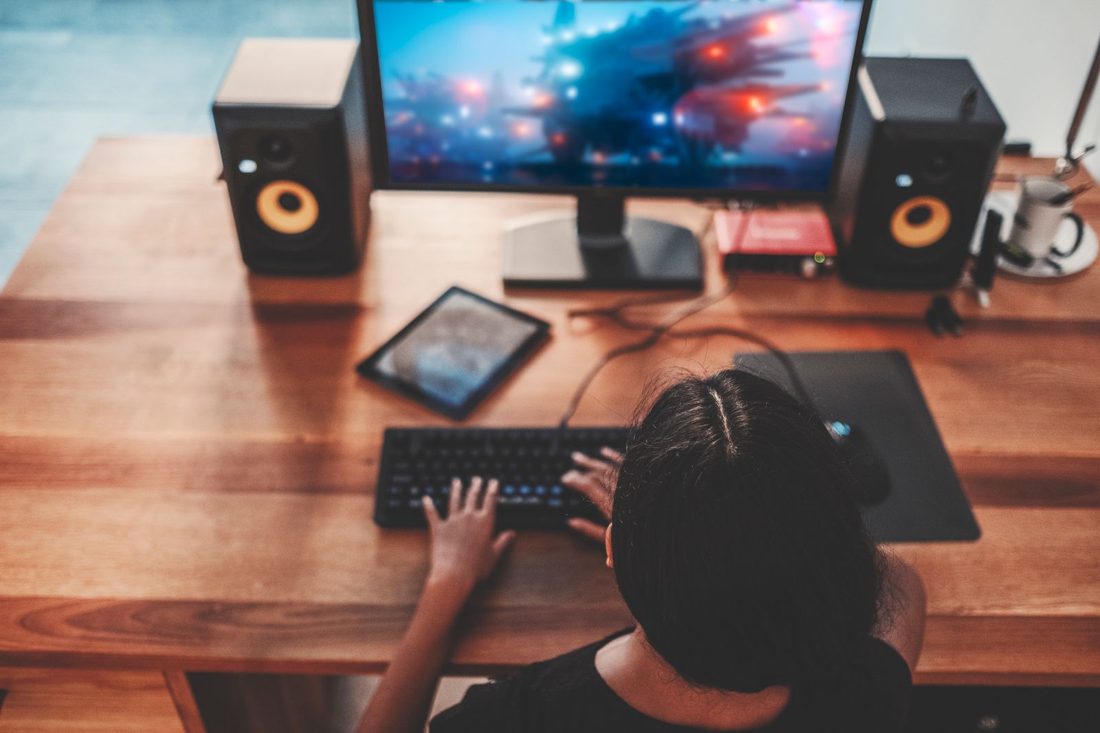 Woman playing videos on desk with large surface