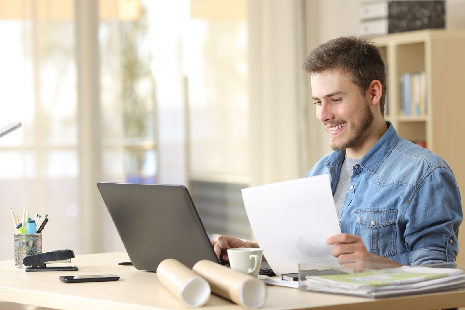 Happy young employee working from home