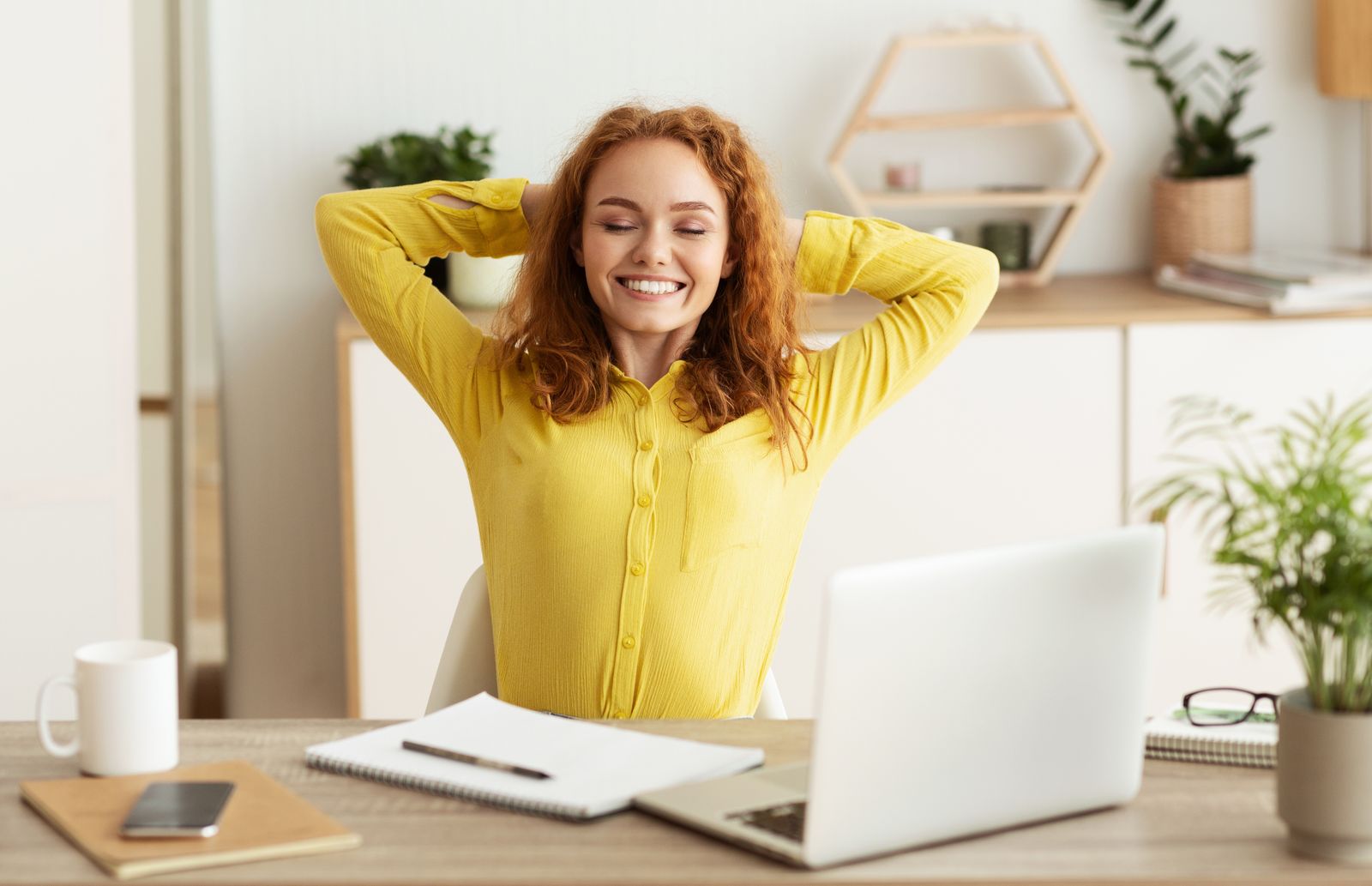 Happy female employee working from home