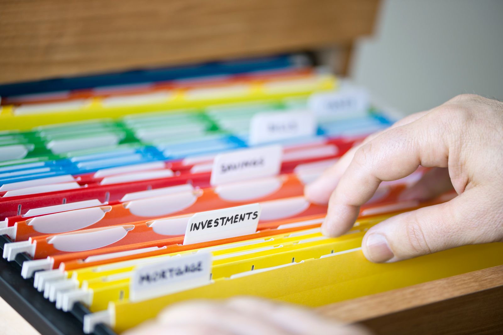 Person looking through color-coded folders