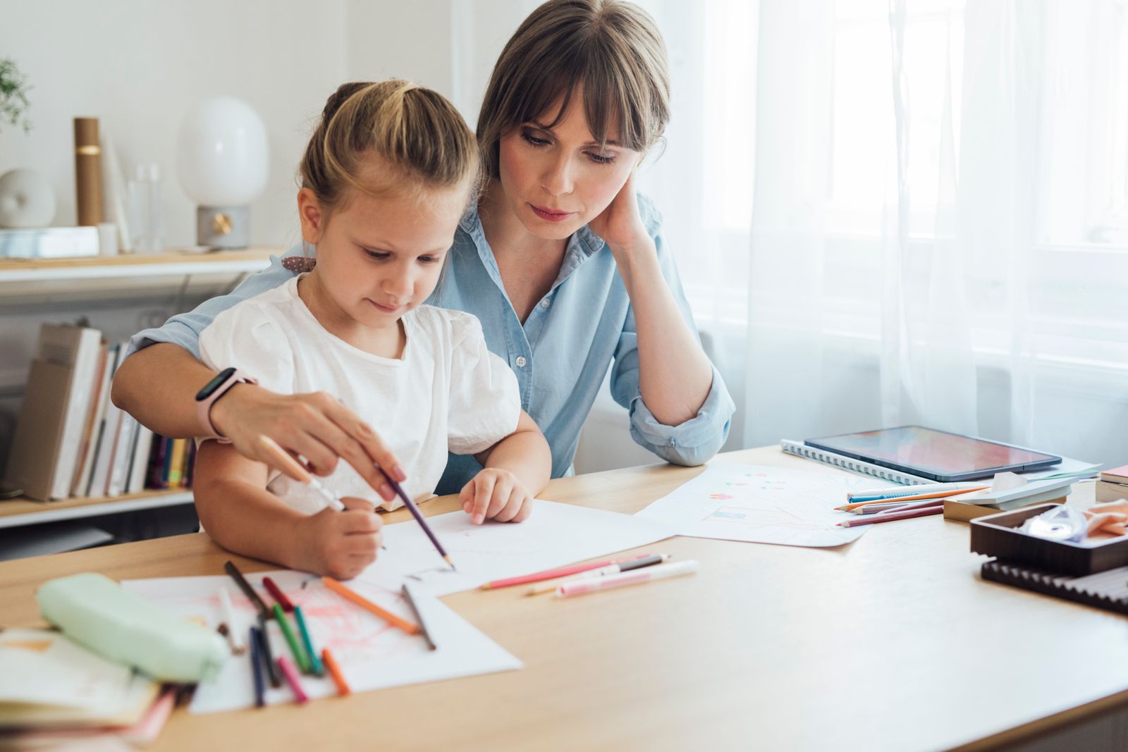 Mother helping her daughter with homework