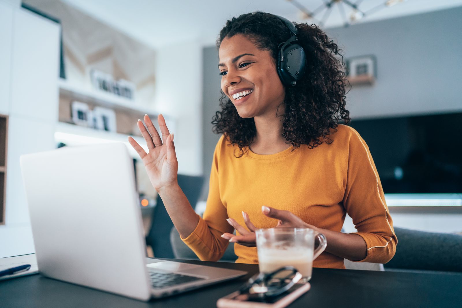 Woman videoconferencing in home office