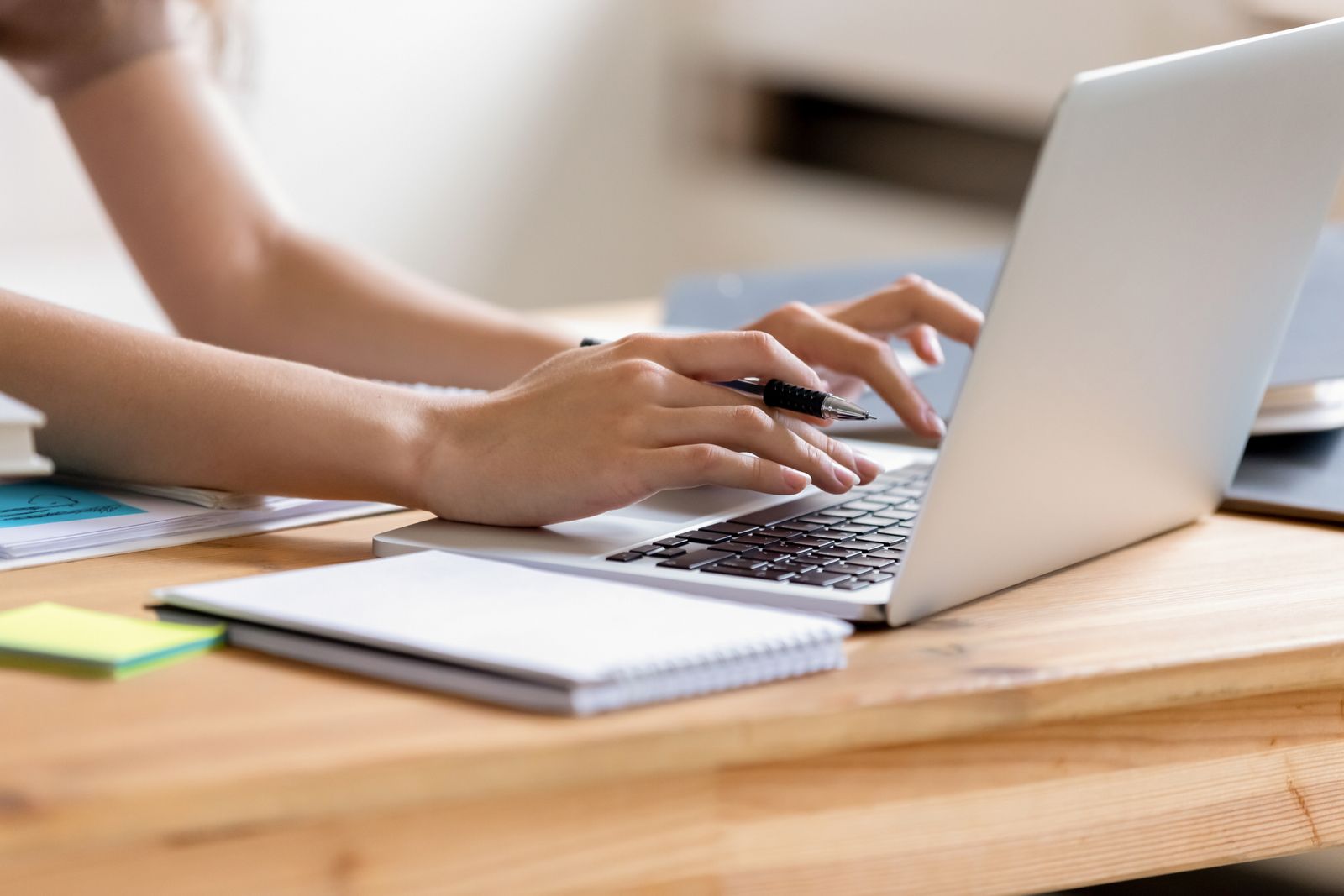 women typing on a laptop