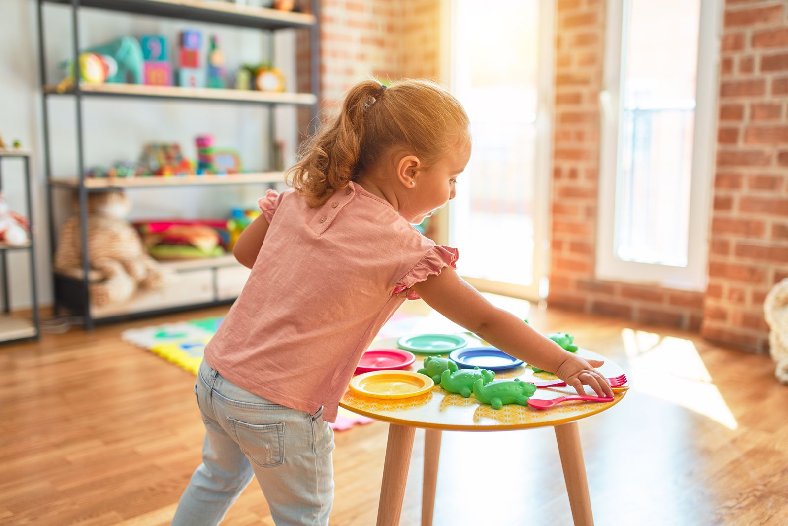 Little girl in a bright playroom