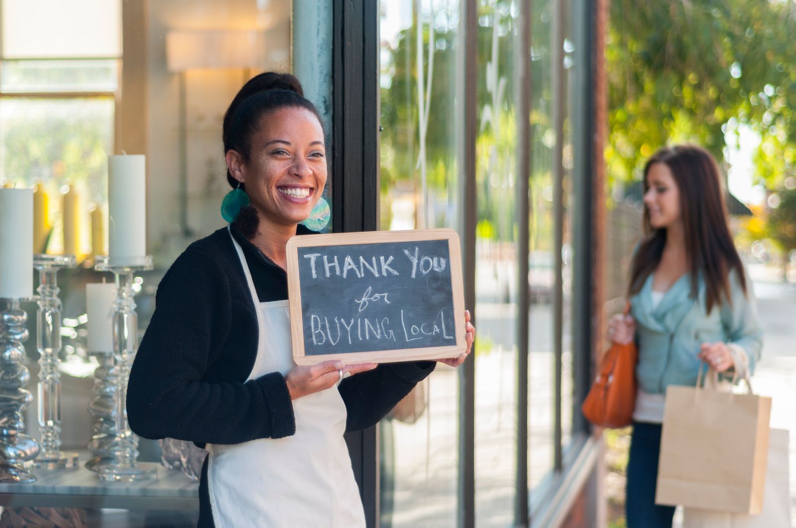 Local business owner thanking people for buying local