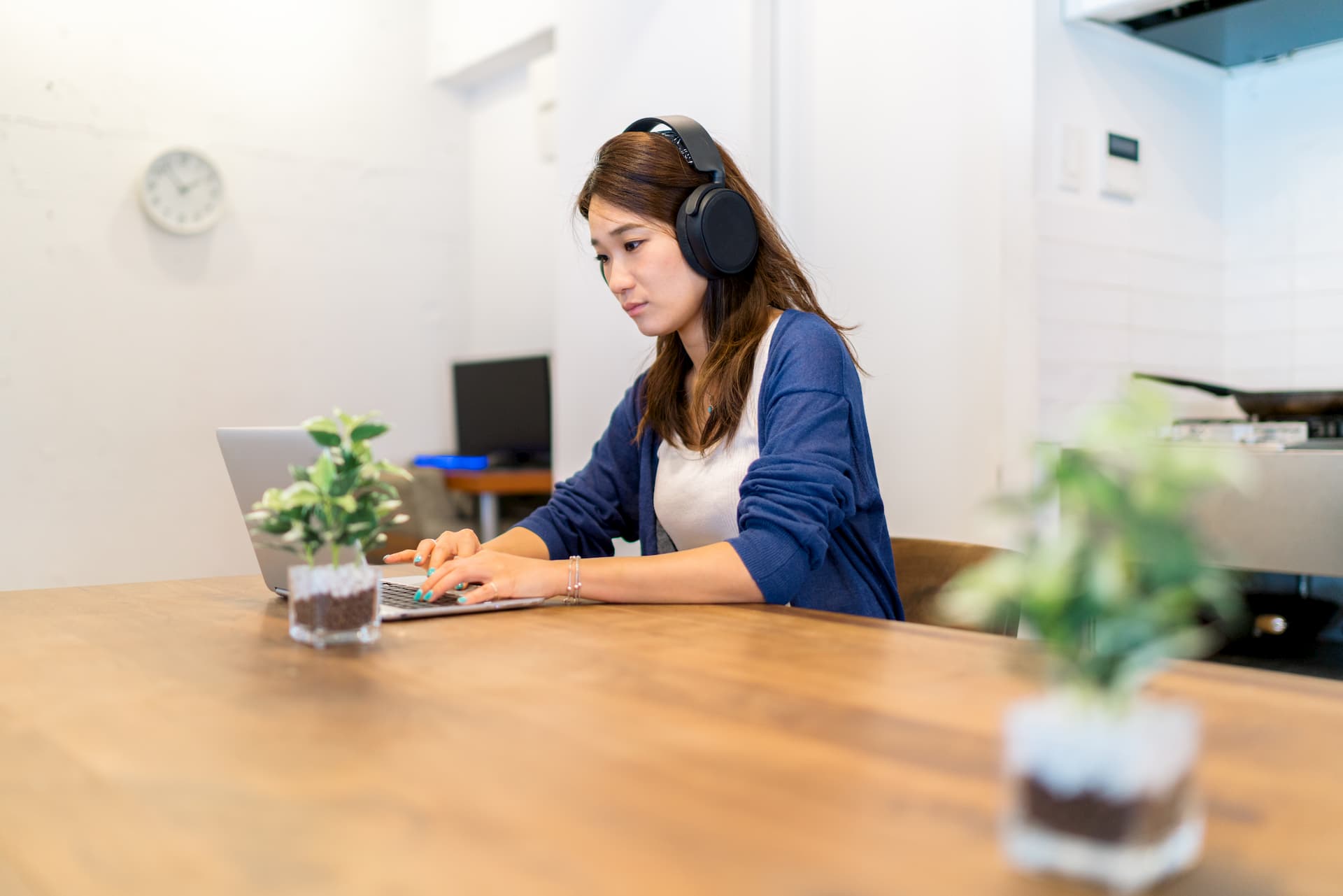 Woman sitting at a table with headphones