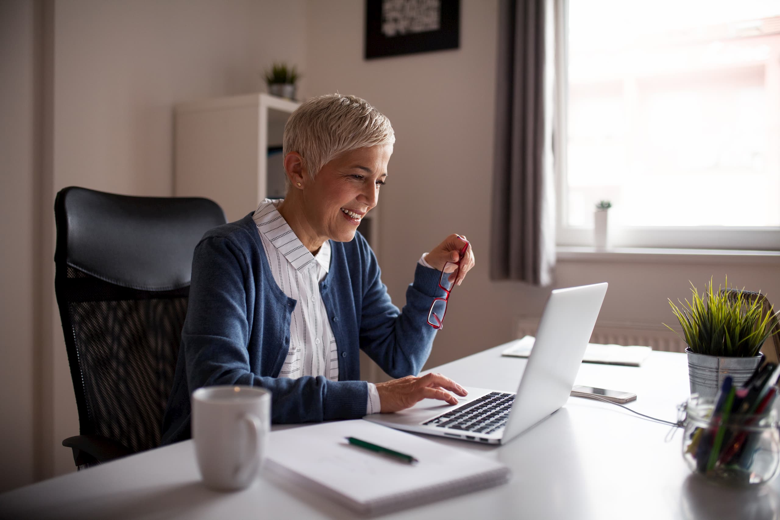 Older woman working in her home office