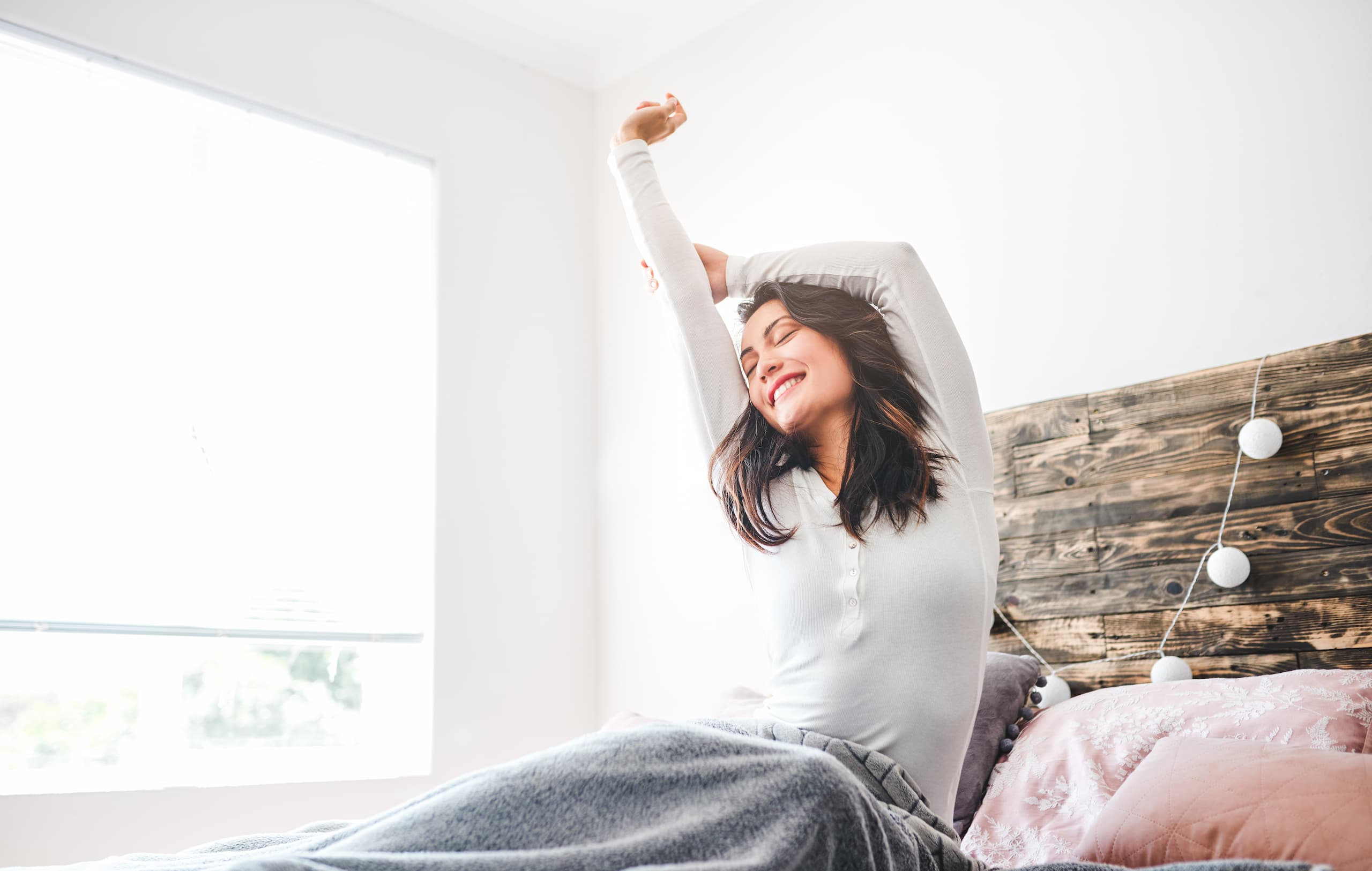 woman waking up white room