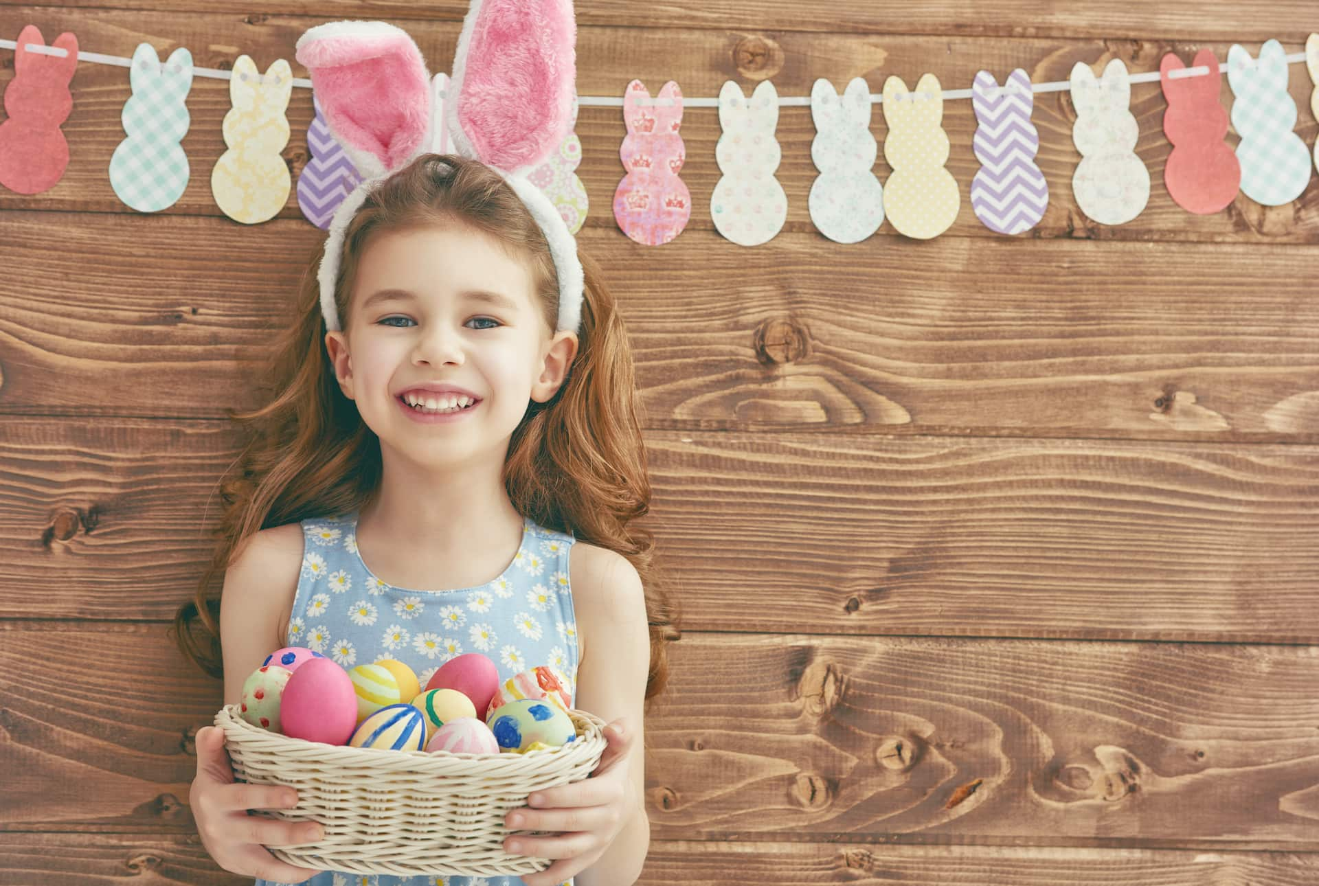 little girl with garland and easter egg basket