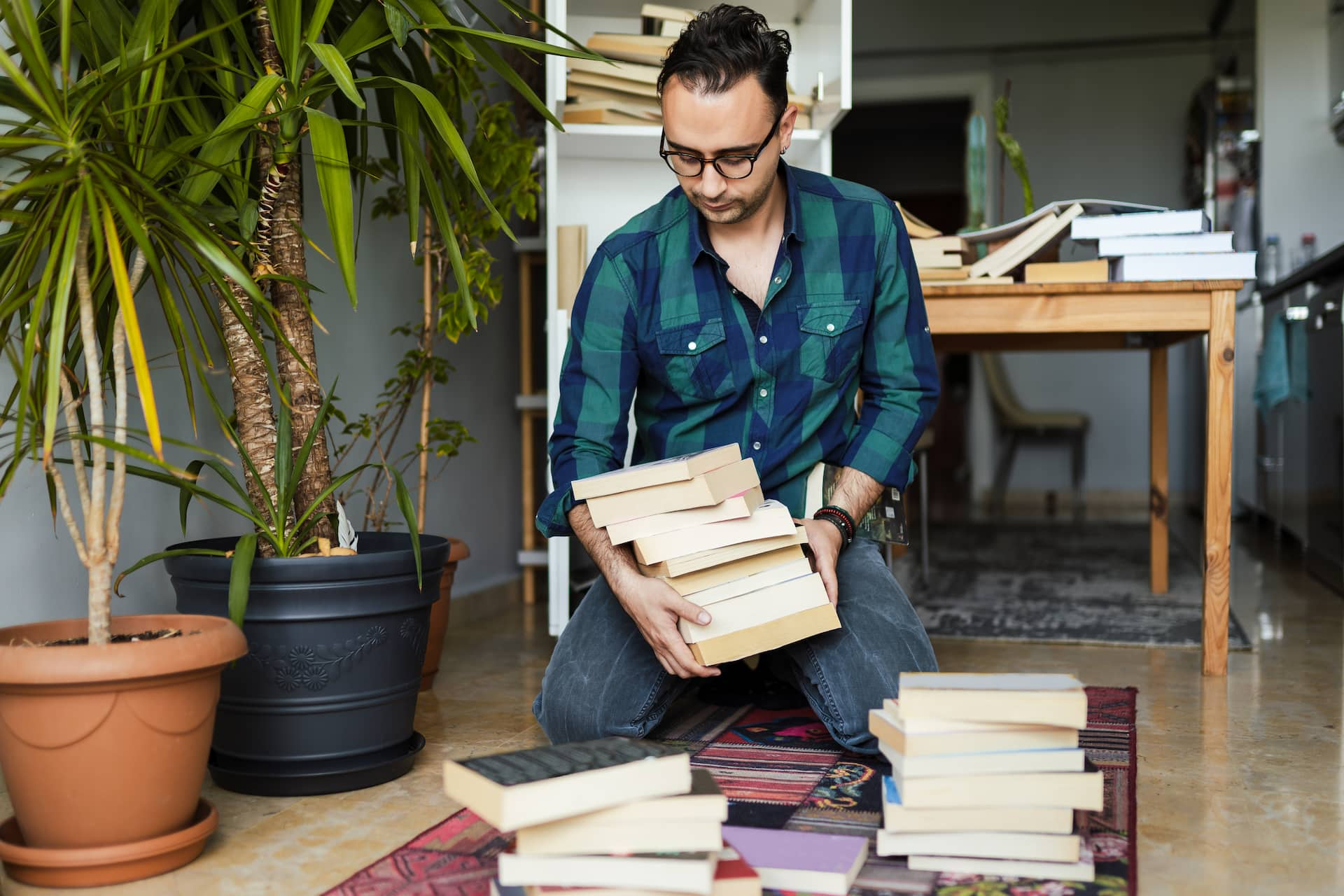 man dropping books