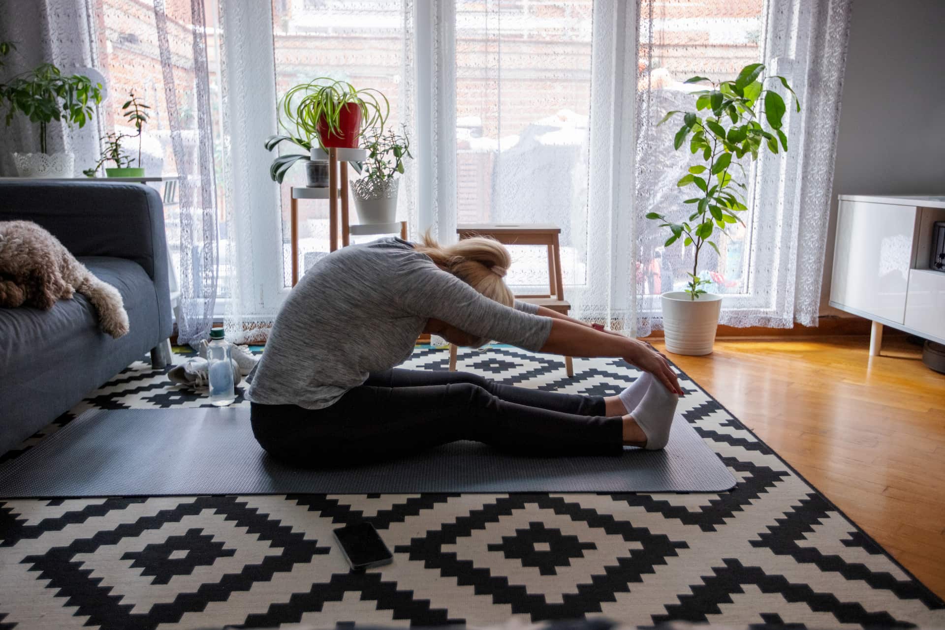 woman doing yoga in living room