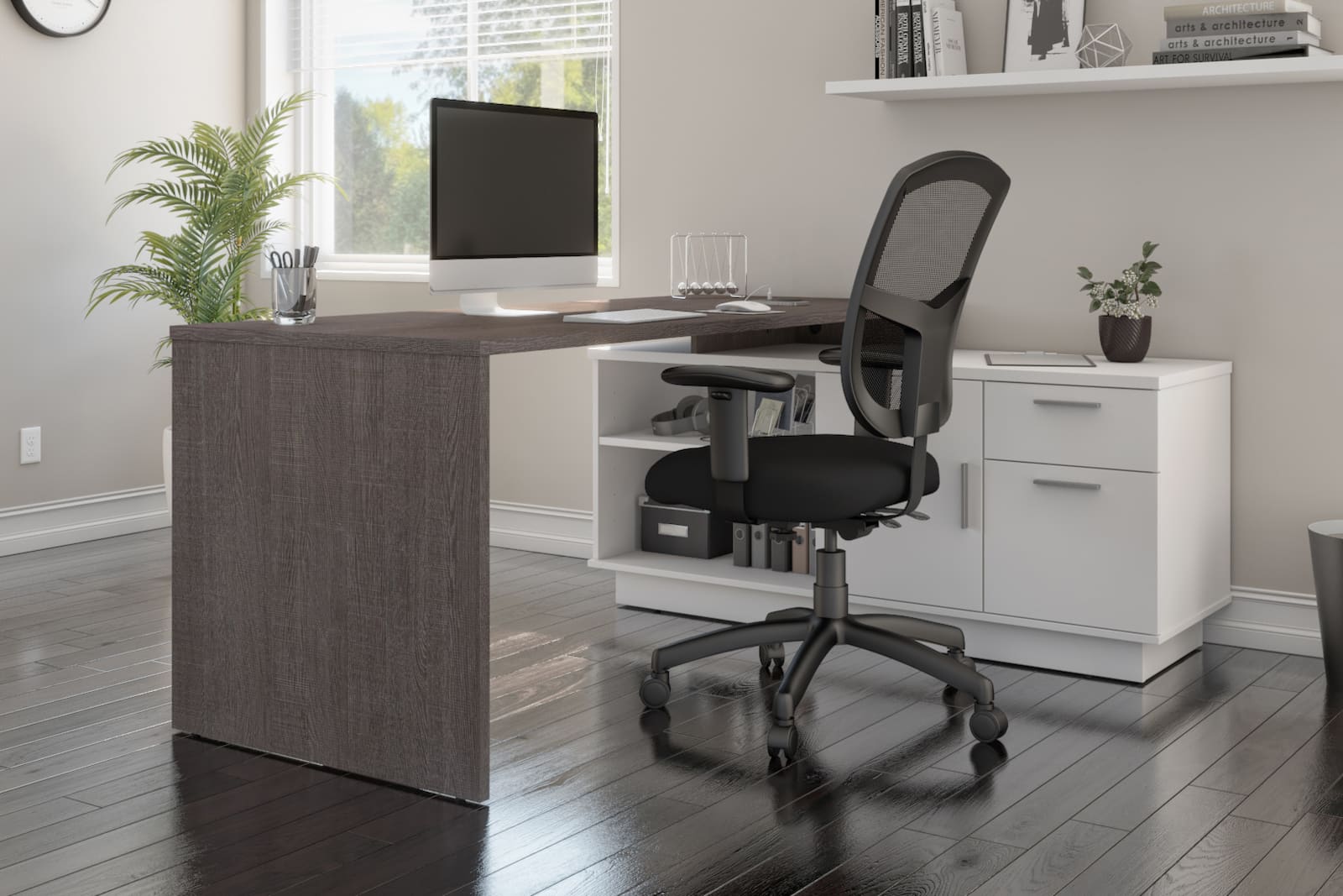 l-shaped desk with white credenza with black swivel chair and potted plant. desk computer on the desk.