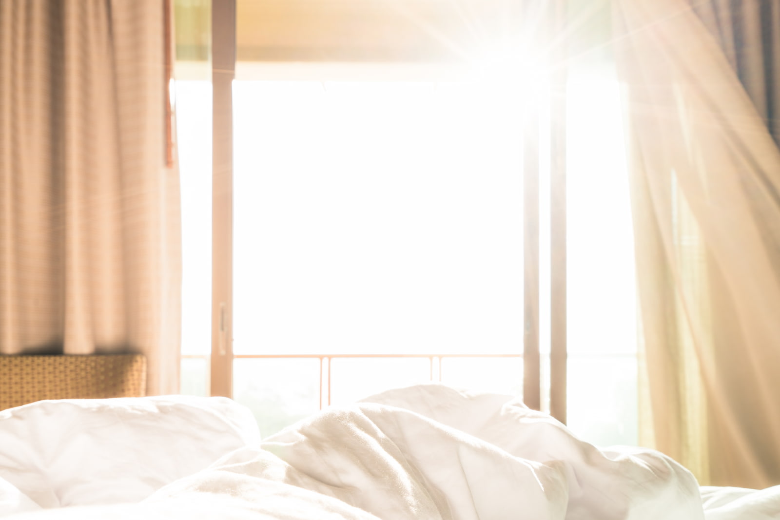 white bed with big window with natural light