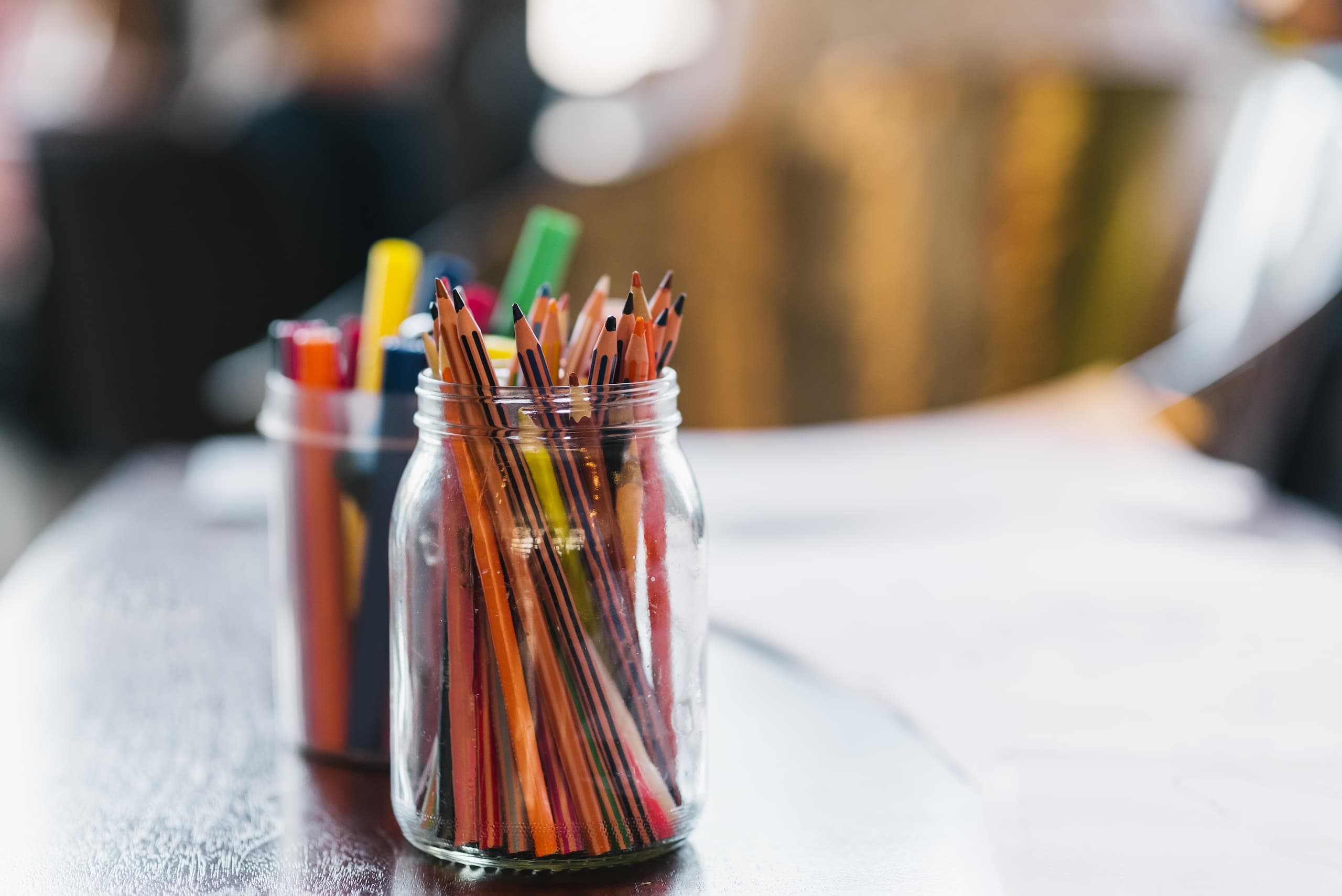 Mason jars full of pencils on a table