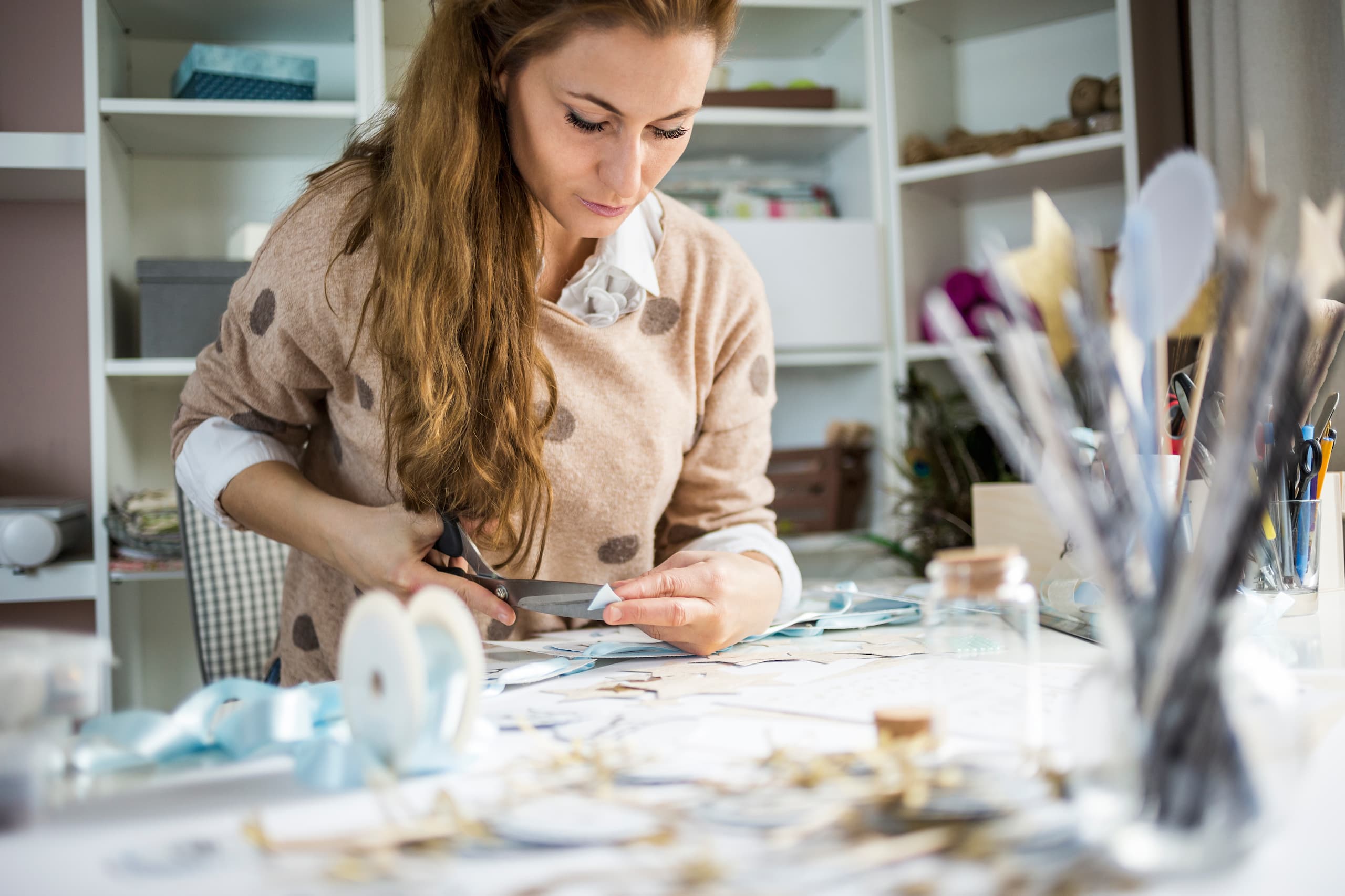 Woman creating a DIY desk organizer