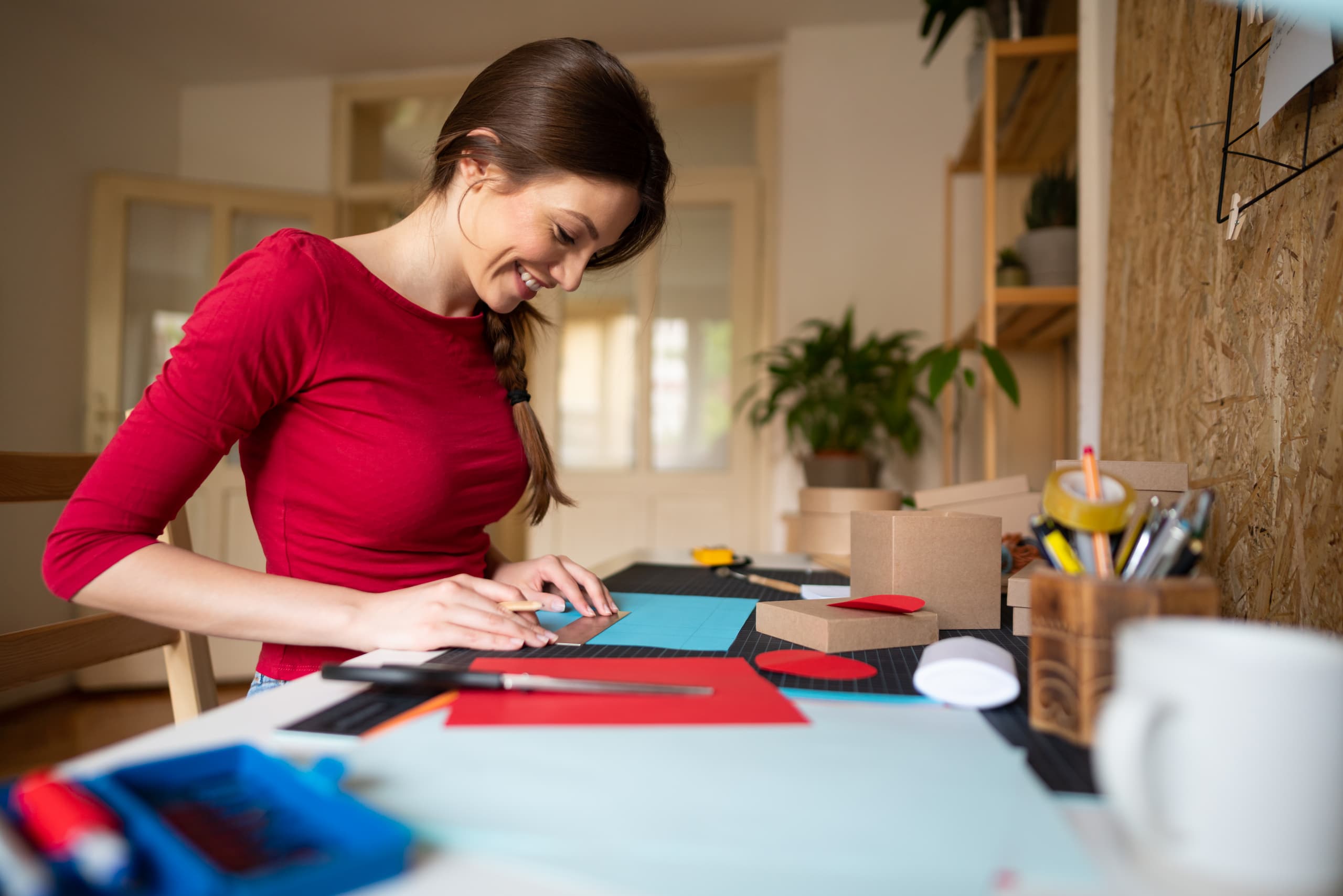 Woman happily making a DIY desk organizer