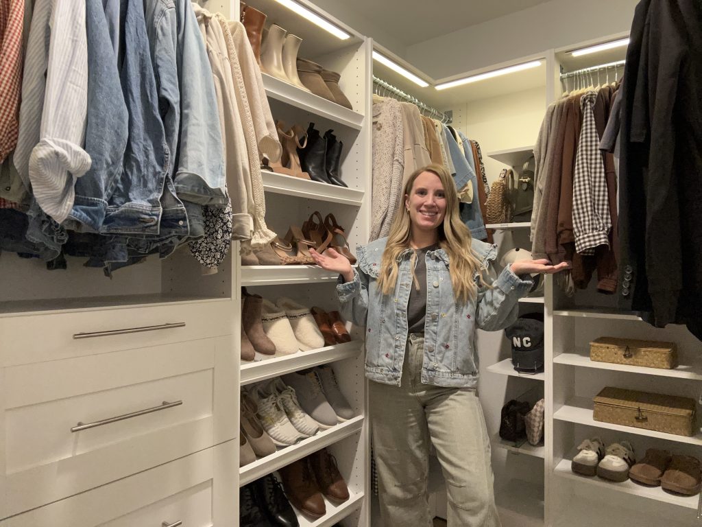 Woman in organized walk-in closet